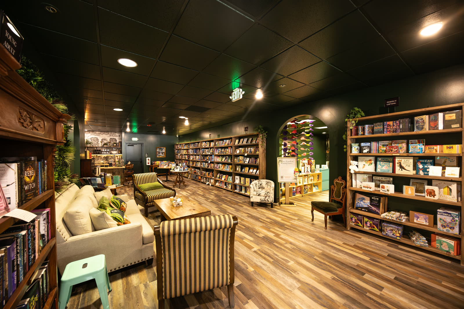 Bookshelves and lounge seating inside Thirsty Caterpillar bookstore in Lake Oswego